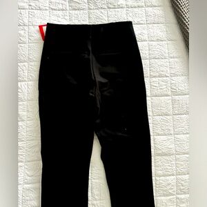 Spanx black pants with white piping down the side, size small